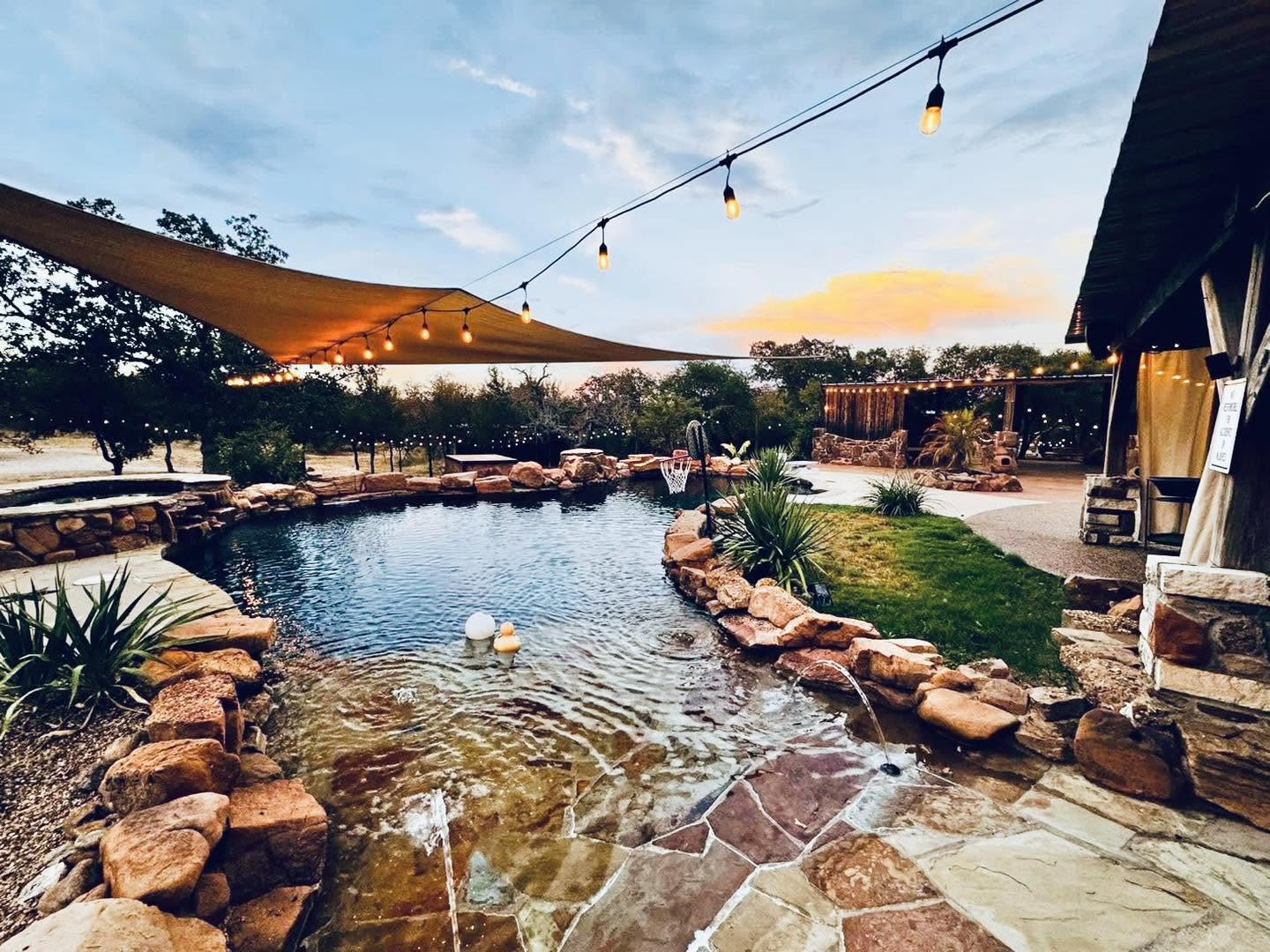 Sunset over the pool under string lights